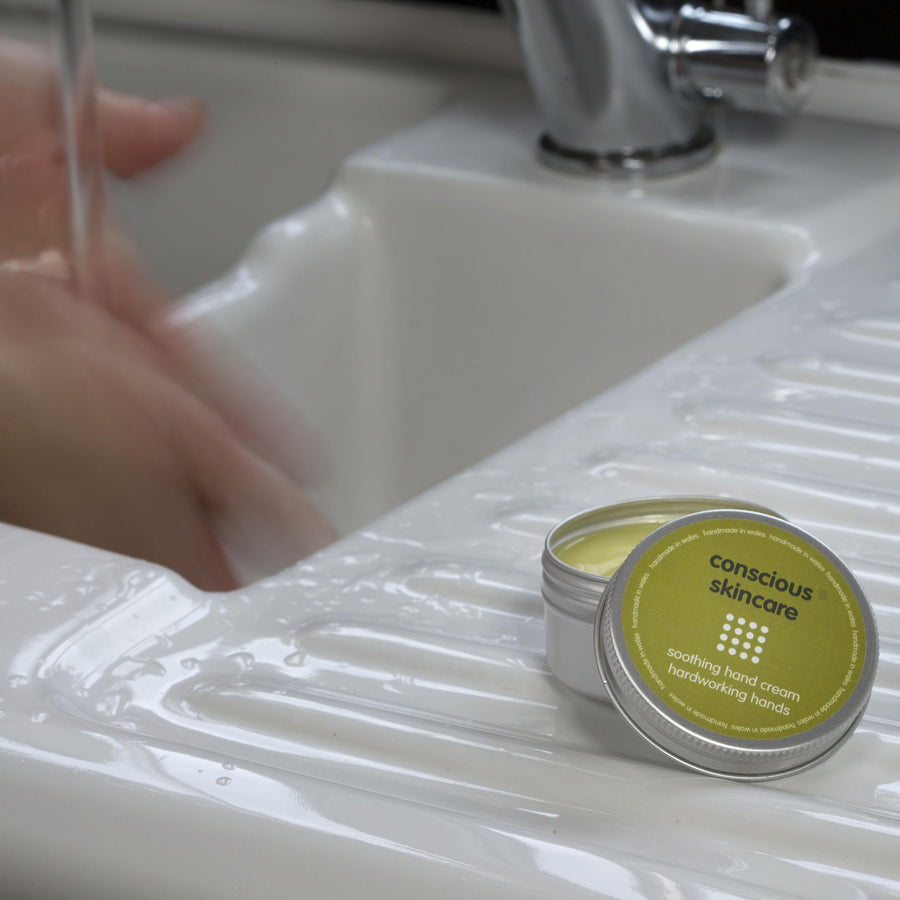 Vegan Hand Cream for Working Hands on a white sink with hands being washed