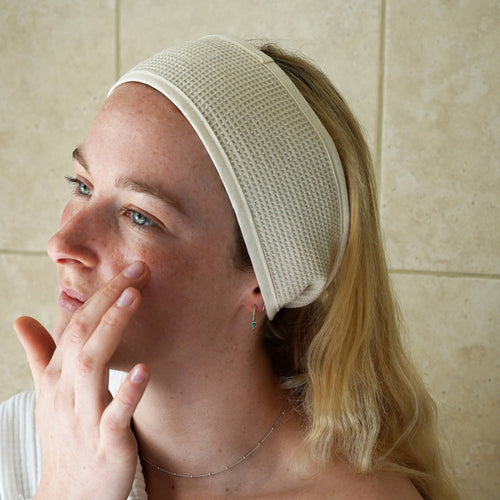 organic cotton skincare headband on girl applying moisturiser in bathroom