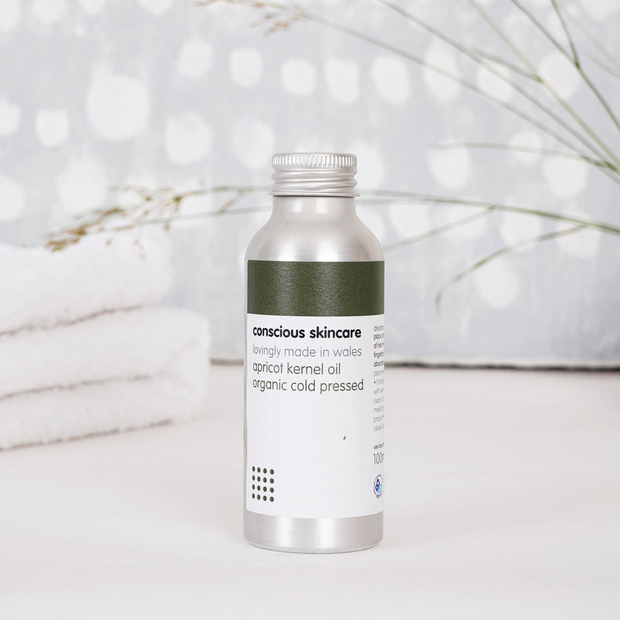 Apricot seed oil bottle in bathroom setting — fast-absorbing care for dry, sensitive skin