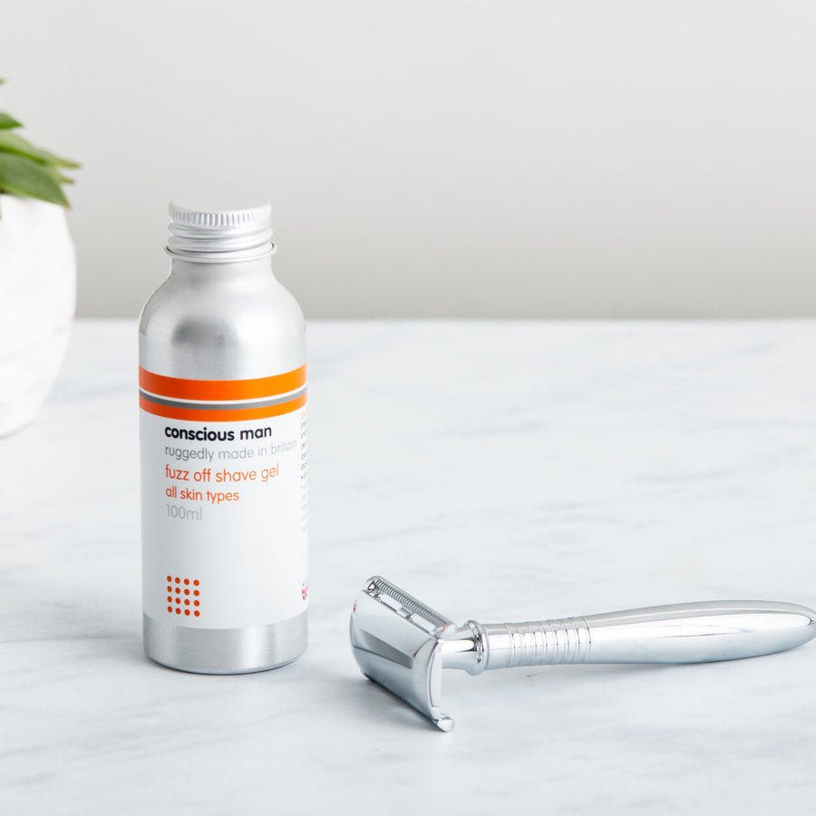 Non-foaming shaving gel beside a metal safety razor — clean glide and easy rinse for daily shave routines.